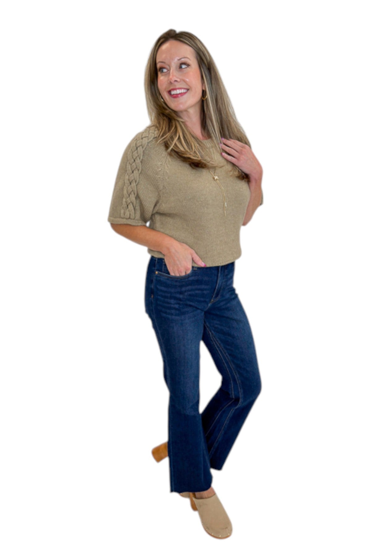 Side view of woman wearing Oatmeal Braid Detail Short Sleeve Sweater by Entro with jeans against white studio background.