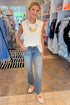 Front view of woman wearing Swagger Boutique’s Smocked Edge Detail Casual Tank Top with jeans at Swagger Boutique.