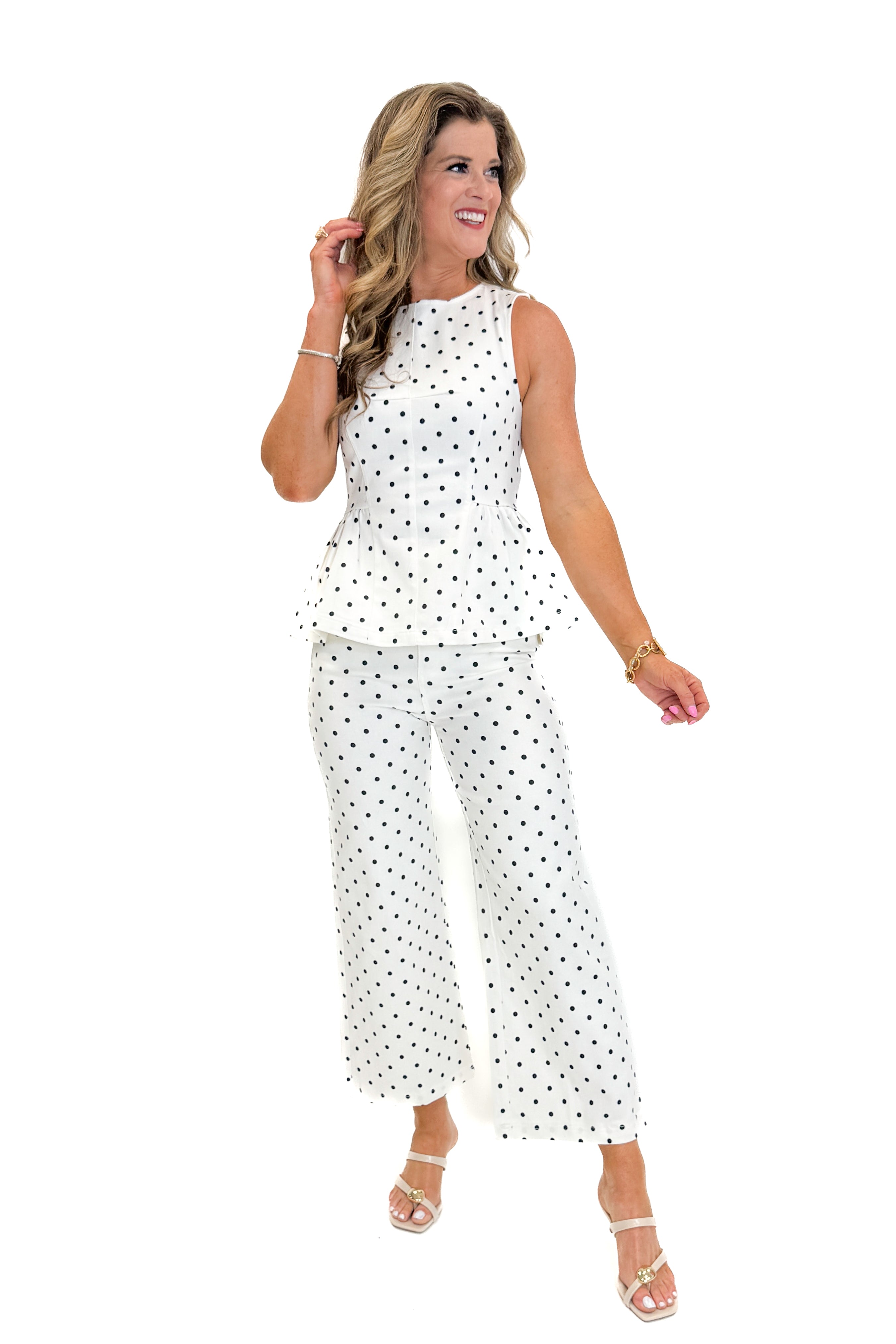 Front view of woman wearing Swagger Boutique’s Off White &amp; Navy Polka Dot Jeans by Entro with matching top against white studio background.