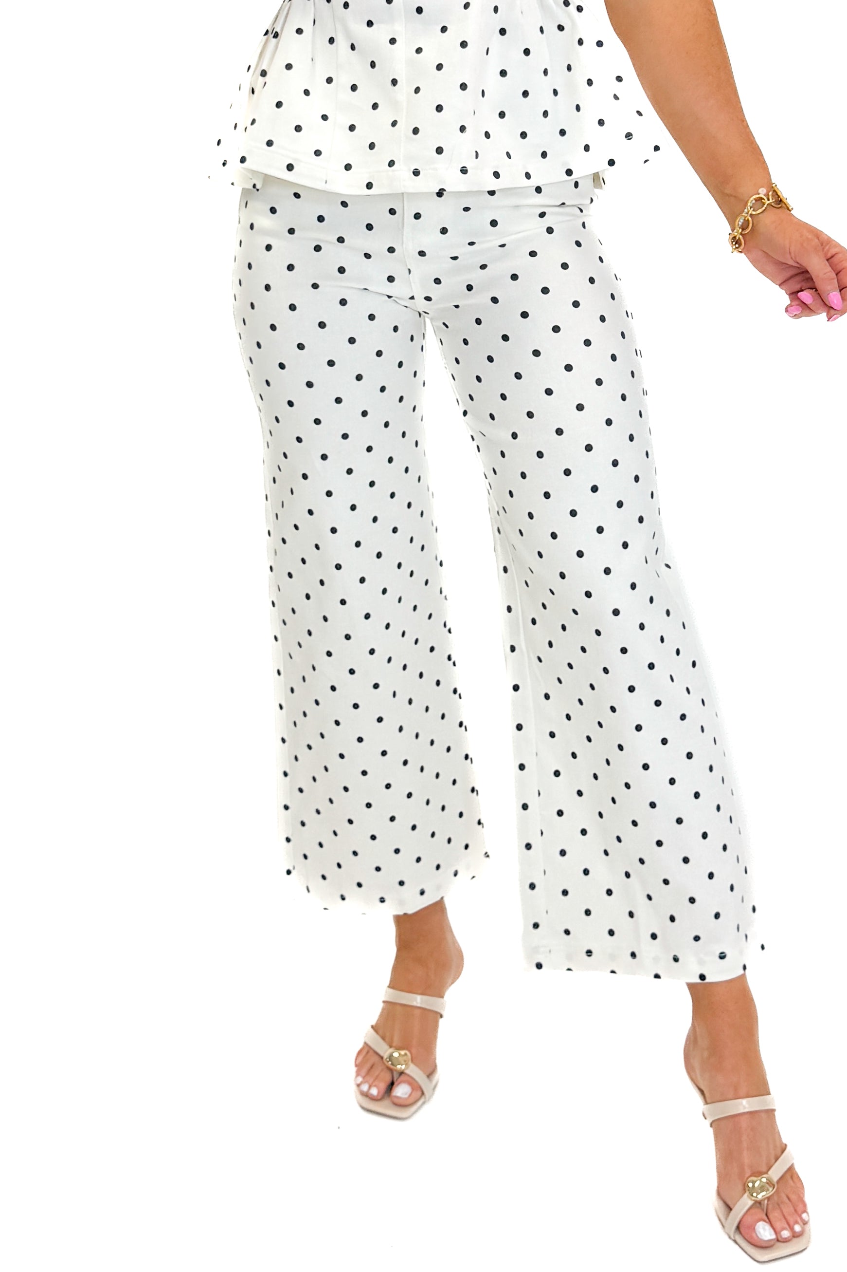 Front detail view of woman wearing Swagger Boutique’s Off White &amp; Navy Polka Dot Jeans by Entro with matching top against white studio background.