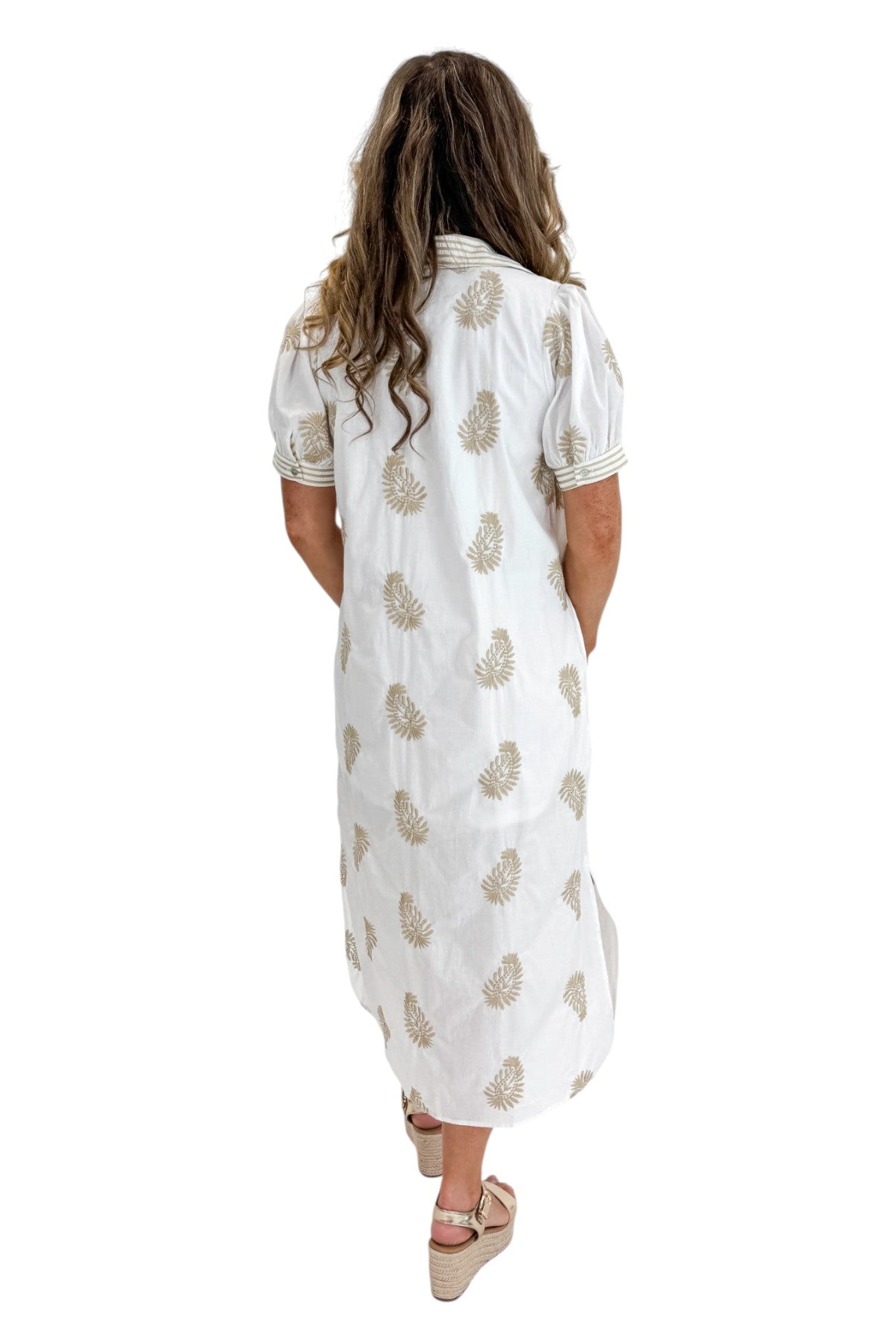 Back view of woman wearing Swagger Boutique’s Off White &amp; Taupe Embroidered Midi Dress with sandals against white studio background.