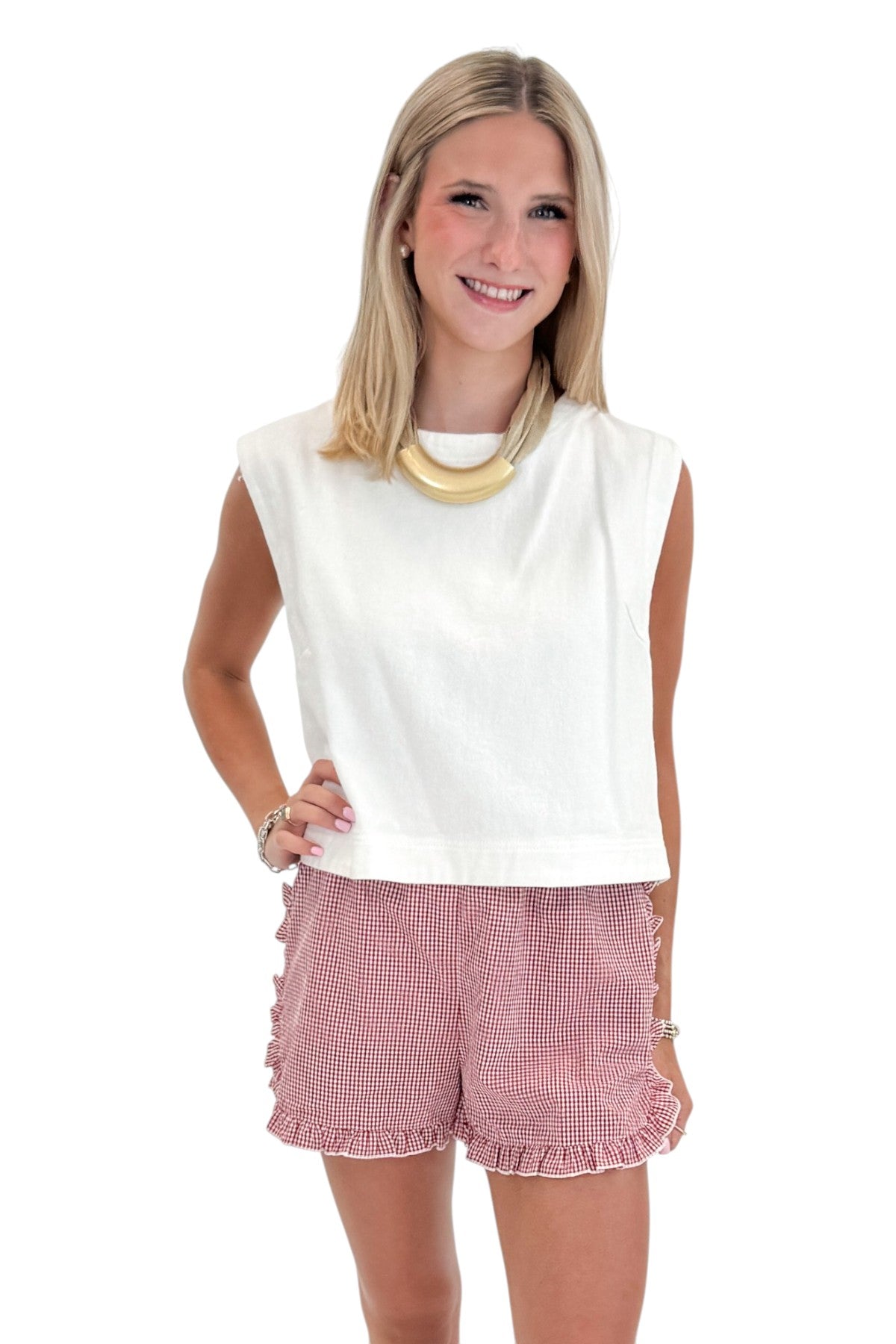 Front view of woman wearing Swagger Boutique’s Red &amp; White Gingham Ruffle Shorts with Off White Cap Sleeve Top by entro against white studio background.