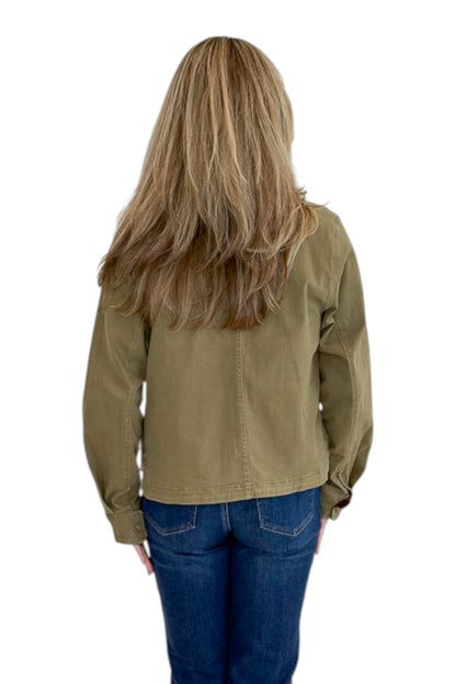 Back view of woman wearing Swagger Boutique’s Olive Barn Jacket With Corduroy Collar with jeans against white studio background.