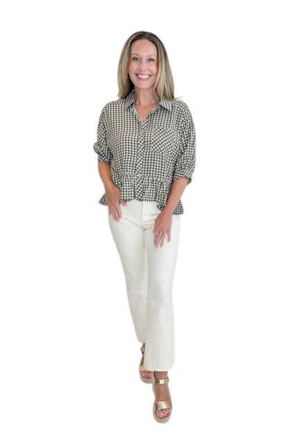 Front view of woman wearing Swagger Boutique’s Olive Gingham Peplum Top by Entro with jeans against white studio background.