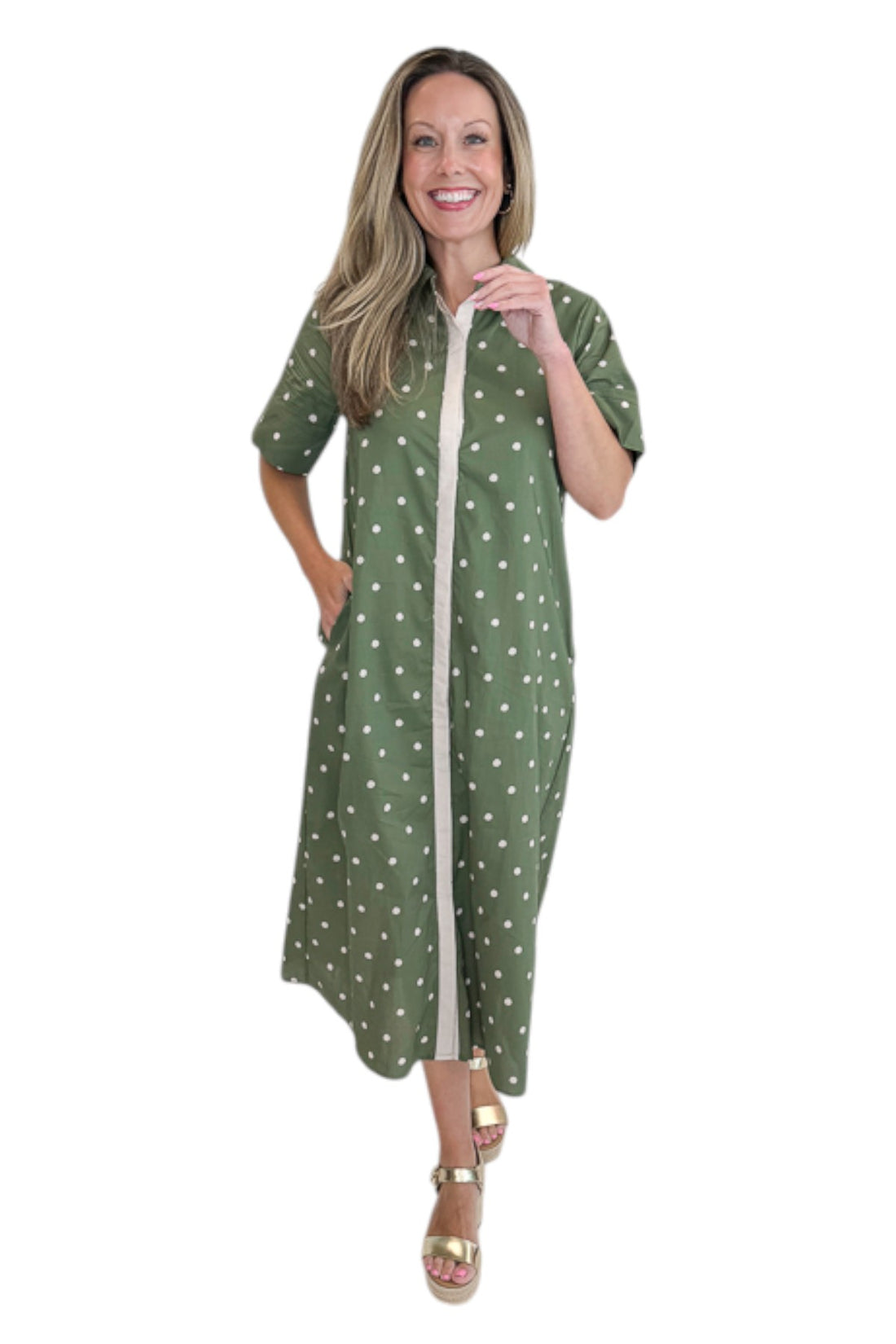 Front view of woman wearing Swagger Boutique’s Olive Polka Dot Midi Dress by Entro with sandals against white studio background.