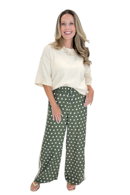 Front view of woman wearing Swagger Boutique’s Cream 3/4 Sleeve Lightweight Sweater by Entro with Olive Polka Dot Stripe Trim Pants by Entro against white studio background.