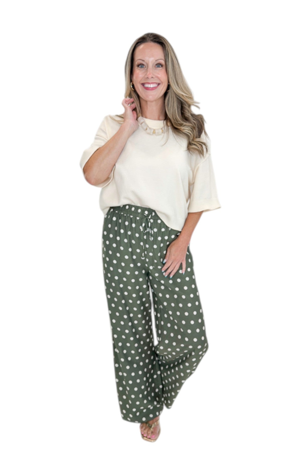 Front view of woman wearing Swagger Boutique’s Cream 3/4 Sleeve Lightweight Sweater by Entro with Olive Polka Dot Stripe Trim Pants by Entro against white studio background.