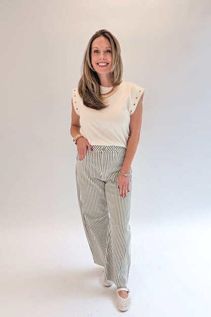 Front view of woman wearing Swagger Boutique’s top with Olive Striped Barrel Jeans by Just Black Denim against white studio background.