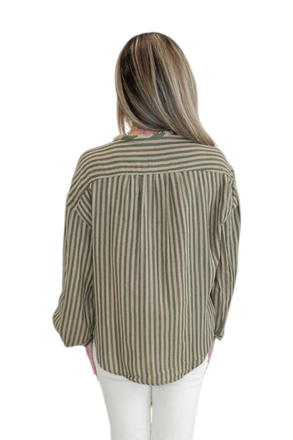 Back view of woman wearing Swagger Boutique’s Olive Striped Button Up Top with jeans against white studio background.