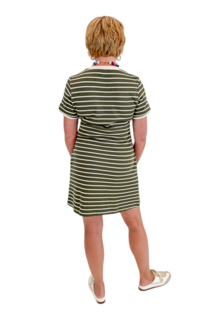 Back view of woman wearing Swagger Boutique’s Olive Striped Tie Waist Mini Dress by Entro with sneakers against white studio background.
