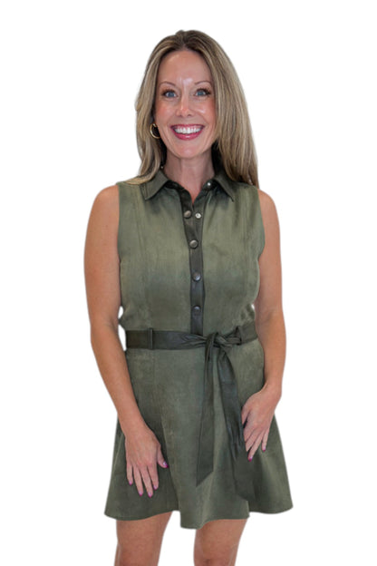 Front view of woman wearing Swagger Boutique’s Olive Suede Mini Dress with heels against white studio background.