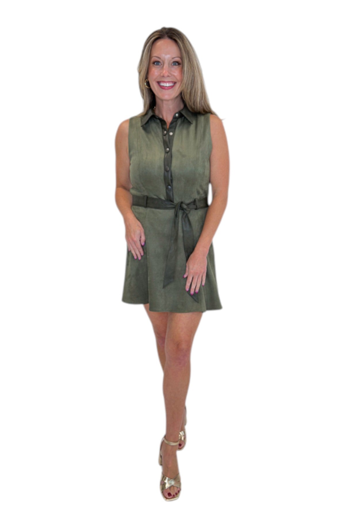 Front view of woman wearing Swagger Boutique’s Olive Suede Mini Dress with heels against white studio background.