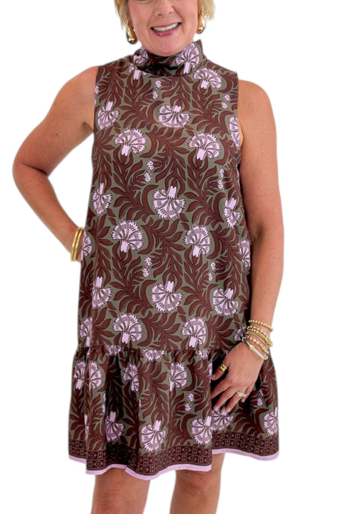 Front detail view of woman wearing Swagger Boutique’s Olive &amp; Brown Floral Halter Neck Mini Dress against white studio background.
