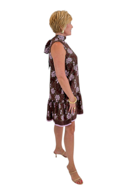Side view of woman wearing Swagger Boutique’s Olive &amp; Brown Floral Halter Neck Mini Dress against white studio background.