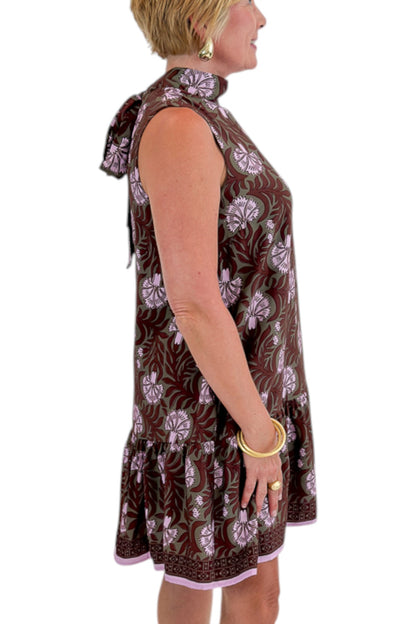 Side detail view of woman wearing Swagger Boutique’s Olive &amp; Brown Floral Halter Neck Mini Dress against white studio background.
