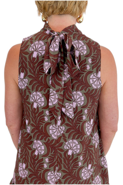 Back detail view of woman wearing Swagger Boutique’s Olive &amp; Brown Floral Halter Neck Mini Dress against white studio background.
