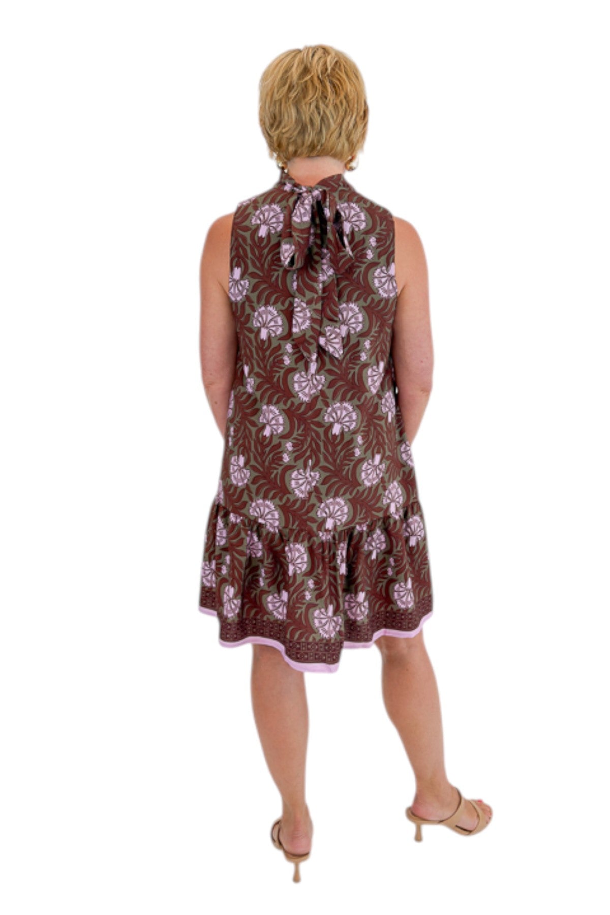 Back view of woman wearing Swagger Boutique’s Olive &amp; Brown Floral Halter Neck Mini Dress against white studio background.