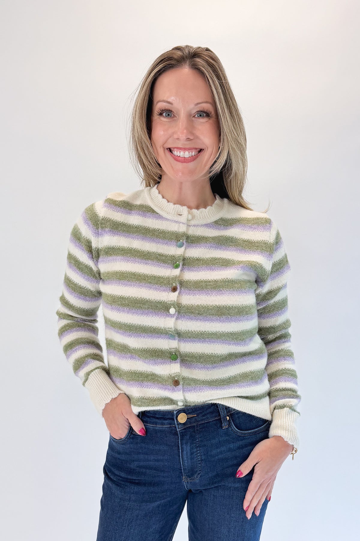 Front view of woman wearing Swagger Boutique’s Olive &amp; Lavendar Striped Button Up Cardigan with jeans against white studio background.