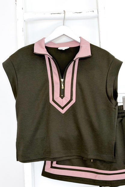 Swagger Boutique’s Olive &amp; Pink Skirt &amp; Matching Top by Entro hanging against white studio background.