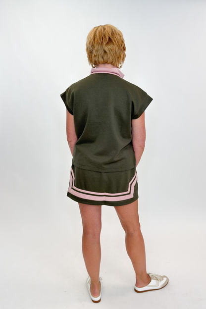Back view of woman wearing Swagger Boutique’s Olive &amp; Pink Half Zip Top &amp; Skirt by Entro against white studio background.