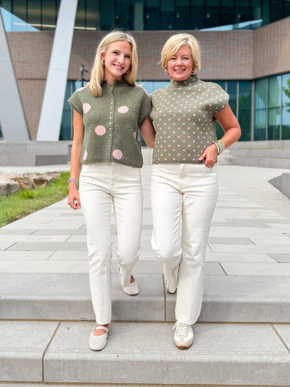 Front view of women wearing Swagger Boutique’s Olive &amp; Pink Polka Dot Sweaters by Entro with jeans walking down a staircase outside.