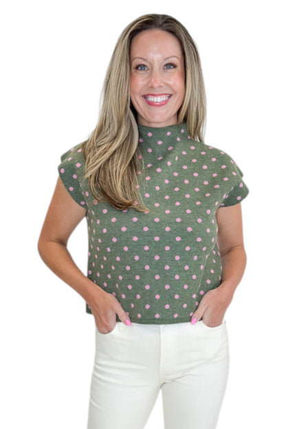Front view of woman wearing Swagger Boutique’s Olive &amp; Pink Polka Dot Sleeveless Sweater by Entro with jeans against white studio background.