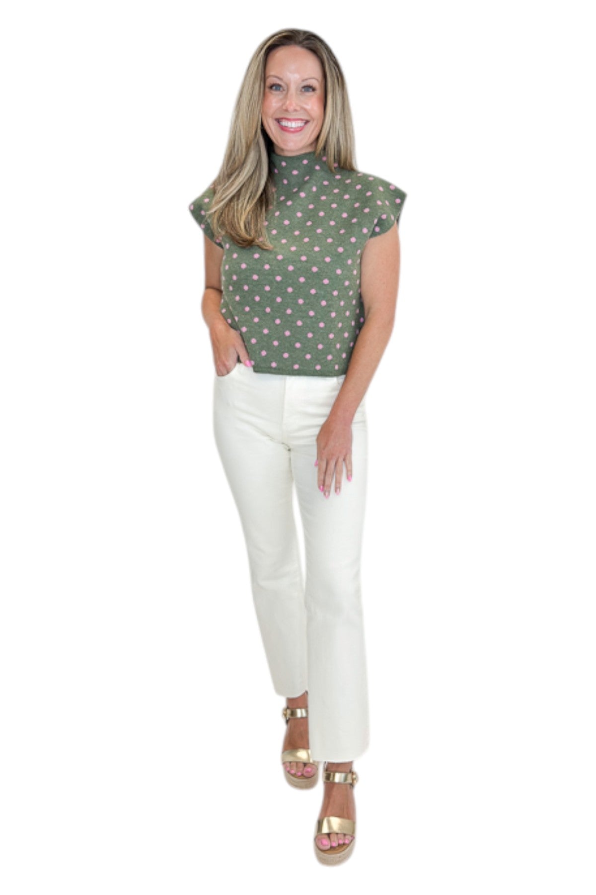 Front view of woman wearing Swagger Boutique’s Olive &amp; Pink Polka Dot Sleeveless Sweater by Entro with jeans against white studio background.