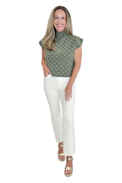 Front view of woman wearing Swagger Boutique’s Olive &amp; Pink Polka Dot Sleeveless Sweater by Entro with jeans against white studio background.