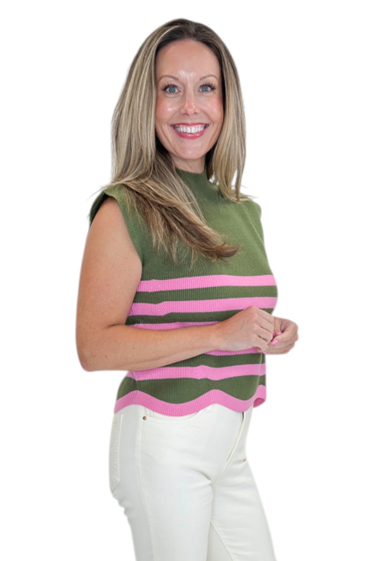 Side view of woman wearing Swagger Boutique’s Olive &amp; Pink Scallop Hem Sleeveless Sweater by Entro with jeans against white studio background.