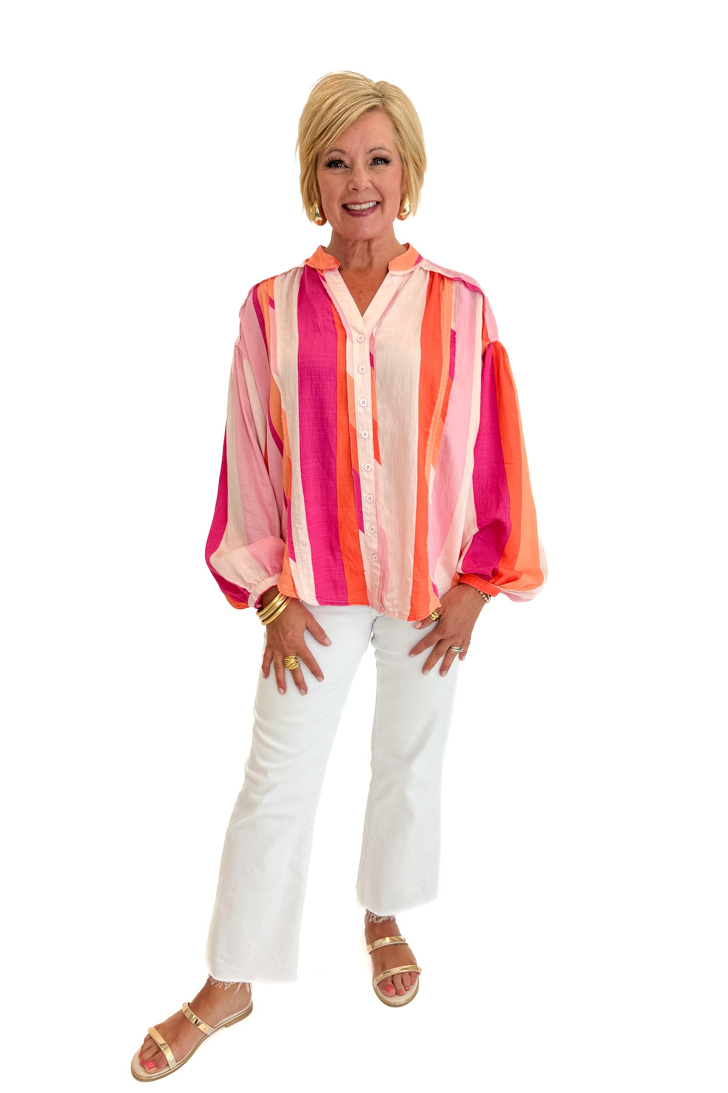 Front view of woman wearing Swagger Boutique’s Orange &amp; Pink Striped Top with jeans against white studio background.