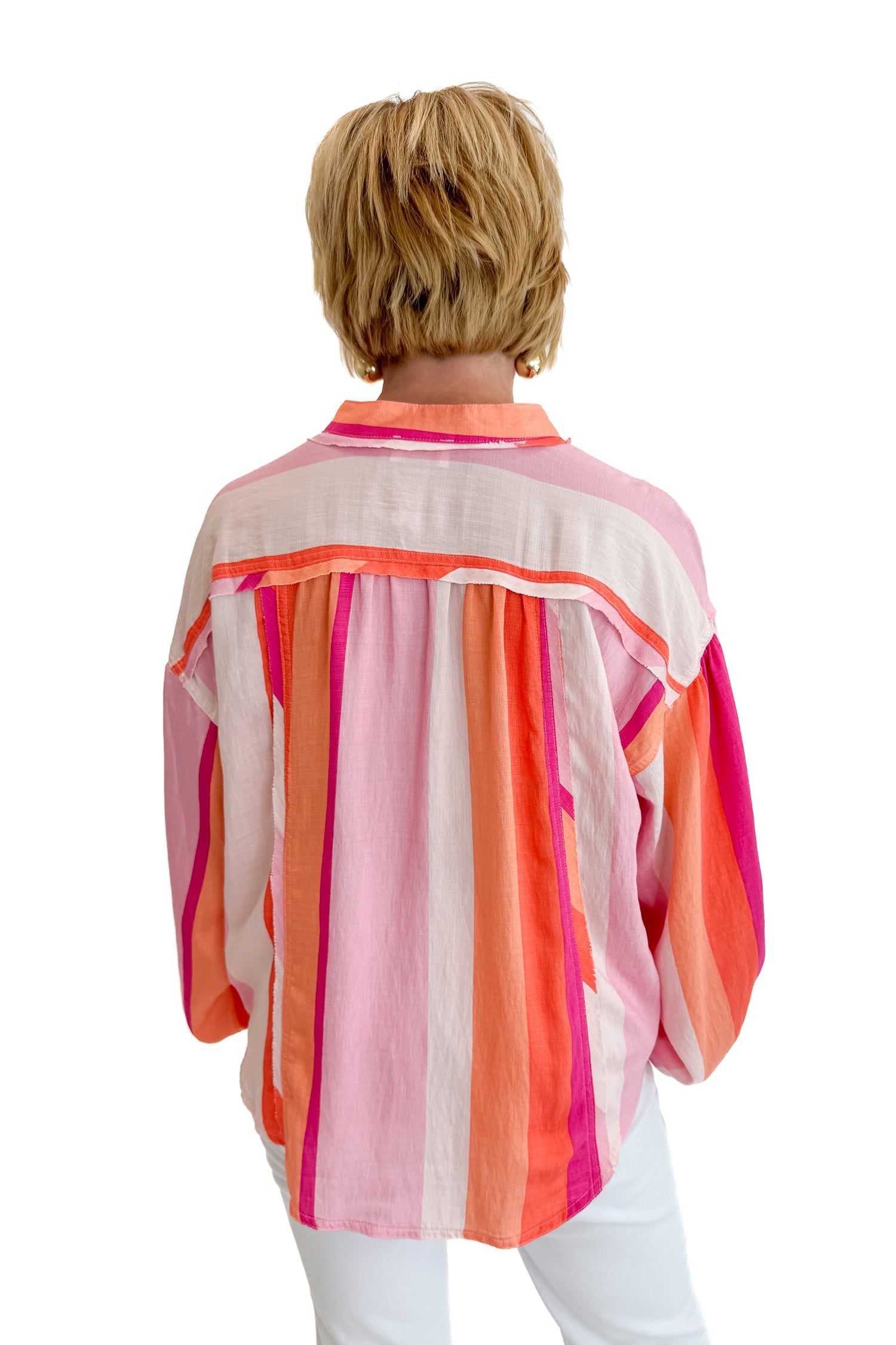 Back view of woman wearing Swagger Boutique’s Orange &amp; Pink Striped Top with jeans against white studio background.