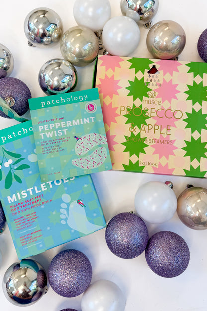 Christmas Shower Steamers &amp; Patchology against holiday background.
