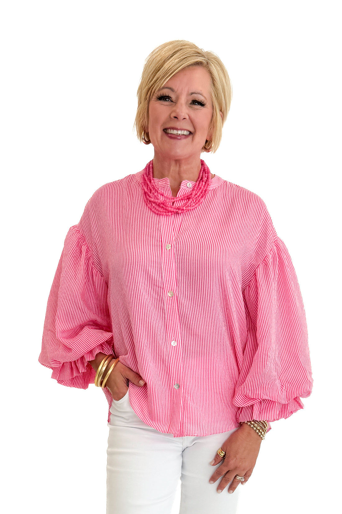 Front view of woman wearing Swagger Boutique’s Pink Pinstripe Bubble Sleeve Top with jeans against white studio background.