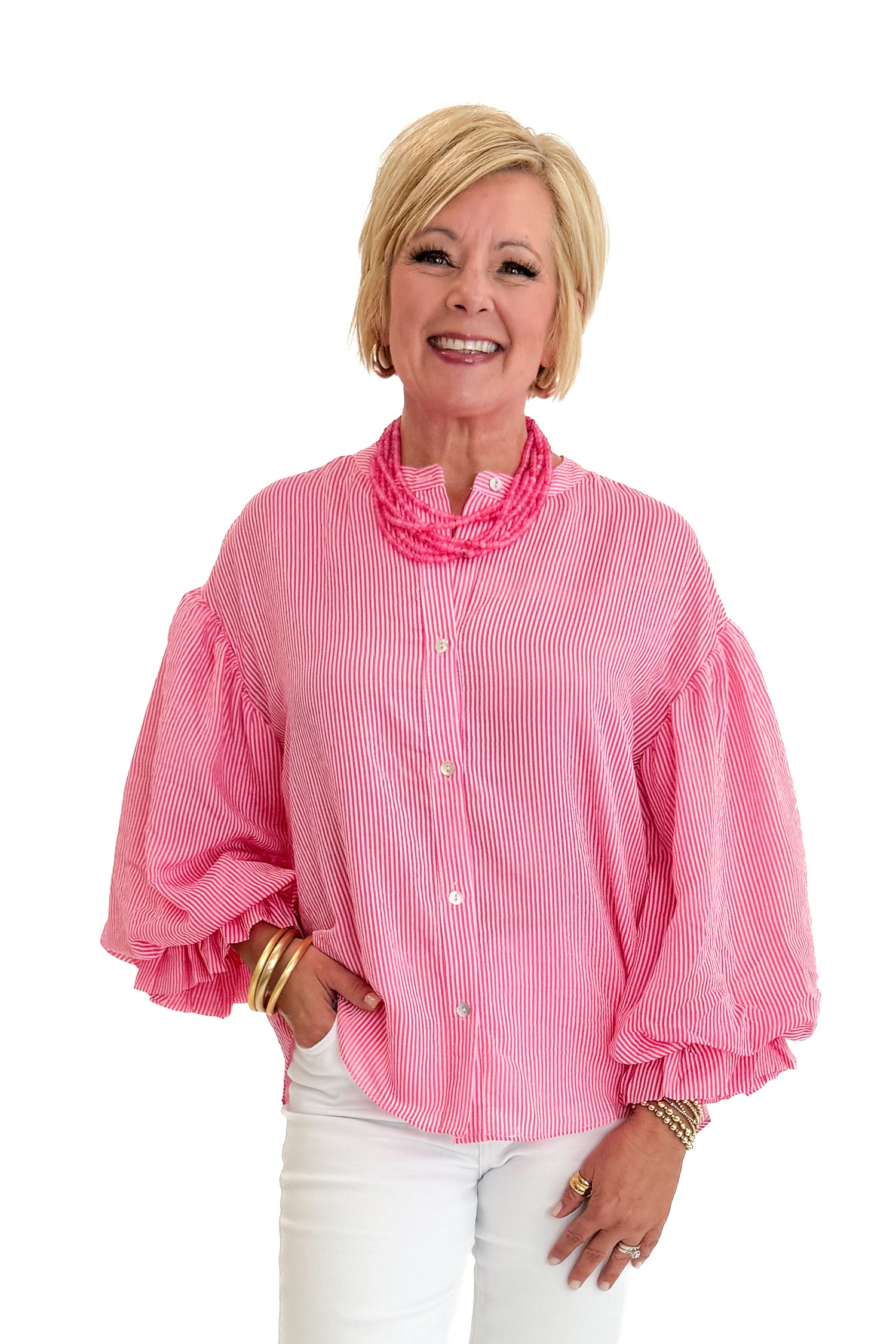 Front view of woman wearing Swagger Boutique’s Pink Pinstripe Bubble Sleeve Top with jeans against white studio background.