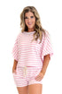 Front view of woman wearing Swagger Boutique’s Pink Striped Terry Cloth Top with matching Pink Striped Terry Cloth Shorts against white studio background.