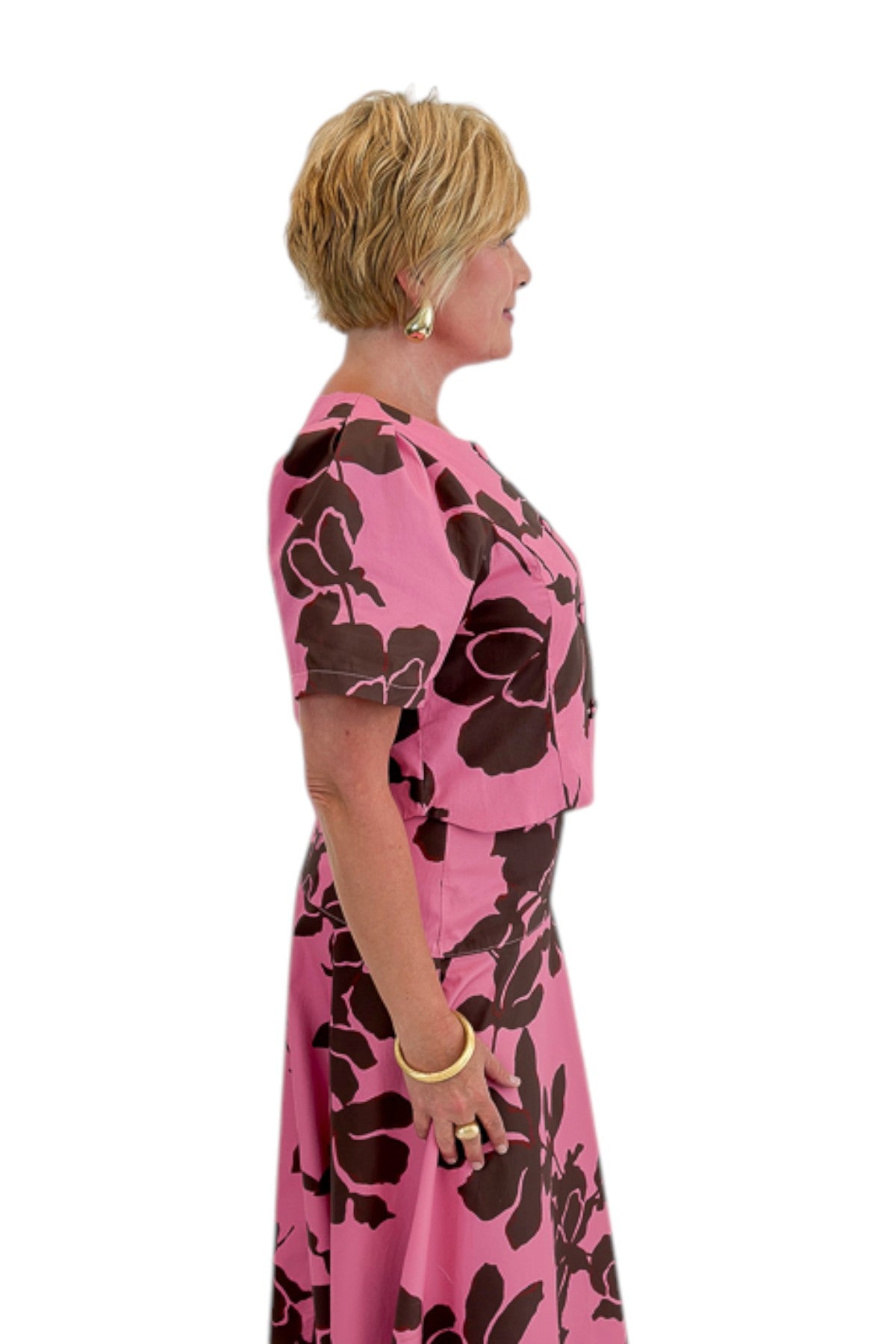 Side view of woman wearing Swagger Boutique’s Pink &amp; Brown Floral Midi Skirt &amp; Pink &amp; Brown Floral Button Up Top by Entro against white studio background.