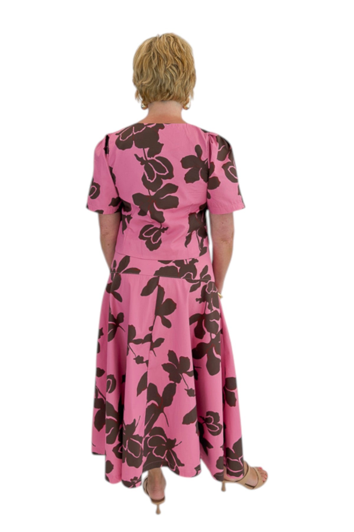 Back view of woman wearing Swagger Boutique’s Pink &amp; Brown Floral Midi Skirt &amp; Pink &amp; Brown Floral Button Up Top by Entro against white studio background.