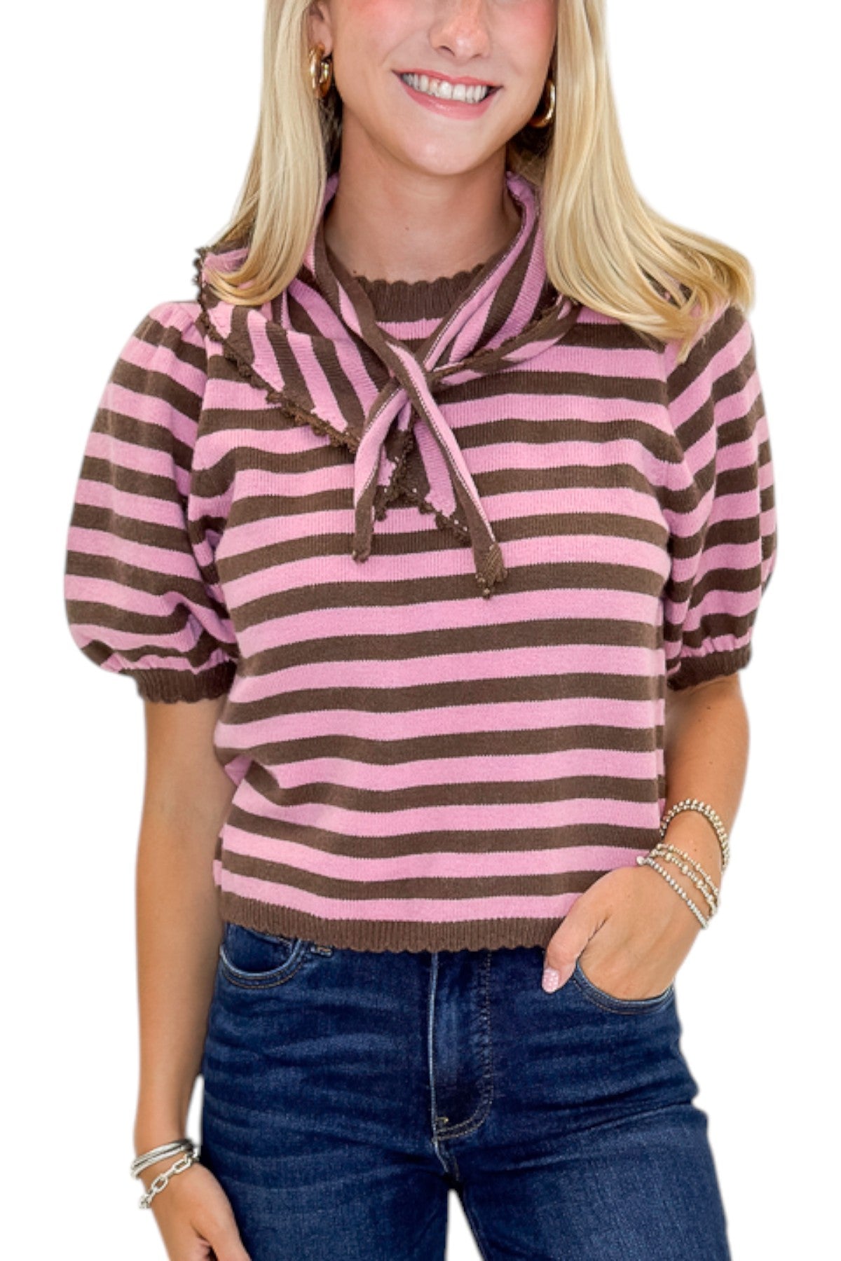 Front detail view of woman wearing Swagger Boutique’s Pink &amp; Brown Striped Faux Tie Short Sleeve Sweater by Entro with jeans against white studio background.