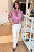 Front view of woman wearing Swagger Boutique’s Pink & Brown Striped Faux Tie Short Sleeve Sweater by Entro with jeans standing at the store.