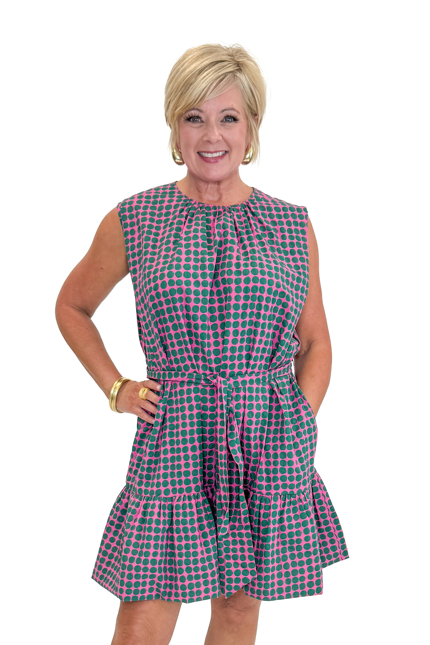 Front view of woman wearing Swagger Boutique’s Pink &amp; Green Polka Dot Mini Dress with sandals against white studio background.
