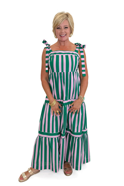 Front view of woman wearing Swagger Boutique’s Pink &amp; Green Striped Tiered Maxi Dress with sandals against white studio background.