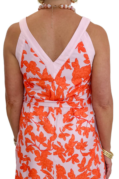 Back detail view of woman wearing Swagger Boutique’s Pink &amp; Orange Floral Midi Dress by Entro with heels against white studio background.
