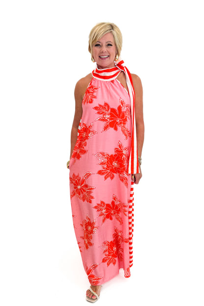 Front view of woman wearing Swagger Boutique’s Pink &amp; Orange Floral &amp; Stripe Maxi Dress by Entro with heels against white studio background.