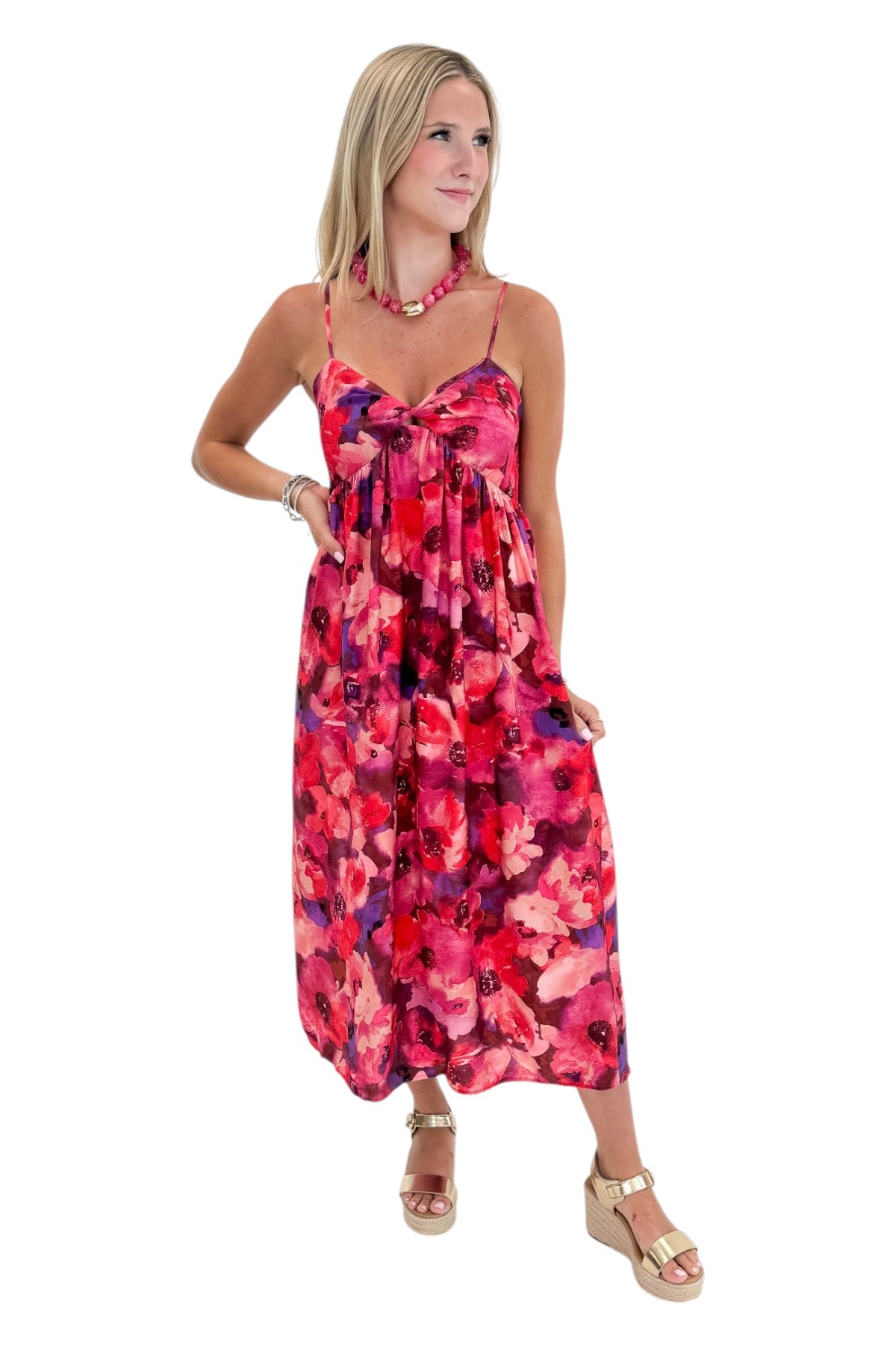 Front view of woman wearing Swagger Boutique’s Pink &amp; Red Floral Midi Dress with sandals against white studio background.