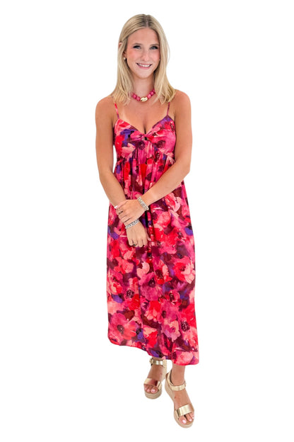 Front view of woman wearing Swagger Boutique’s Pink &amp; Red Floral Midi Dress with sandals against white studio background.