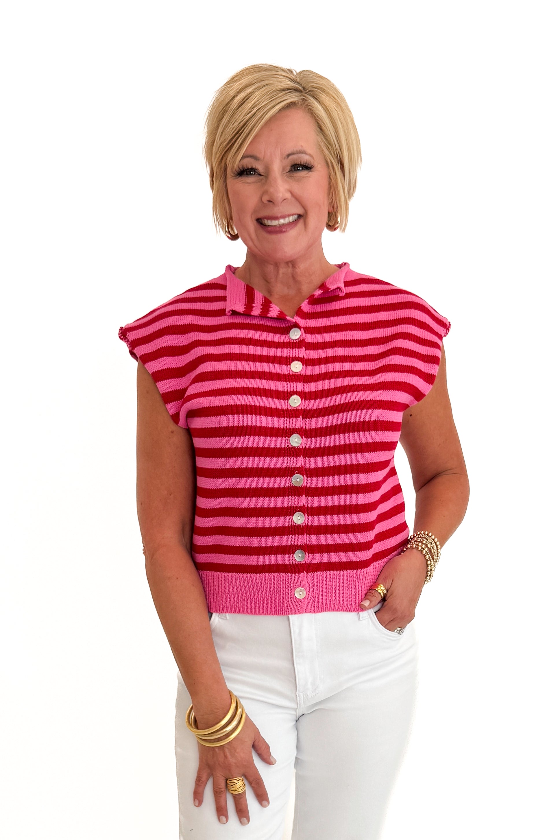Front view of woman wearing Swagger Boutique’s Pink &amp; Red Striped Sleeveless Button Up Sweater by Entro with jeans against white studio background.