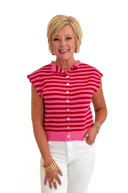 Front view of woman wearing Swagger Boutique’s Pink &amp; Red Striped Sleeveless Button Up Sweater by Entro with jeans against white studio background.