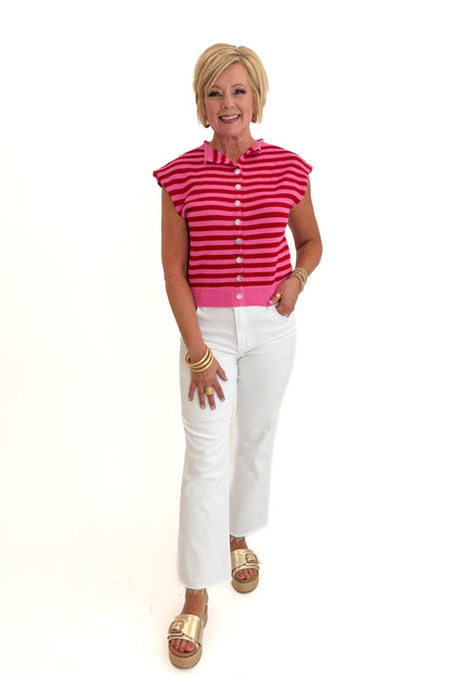Front view of woman wearing Swagger Boutique’s Pink &amp; Red Striped Sleeveless Button Up Sweater by Entro with jeans against white studio background.
