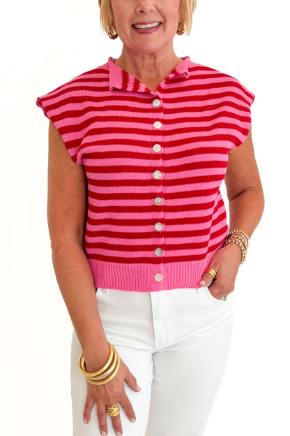Front detail view of woman wearing Swagger Boutique’s Pink &amp; Red Striped Sleeveless Button Up Sweater by Entro with jeans against white studio background.