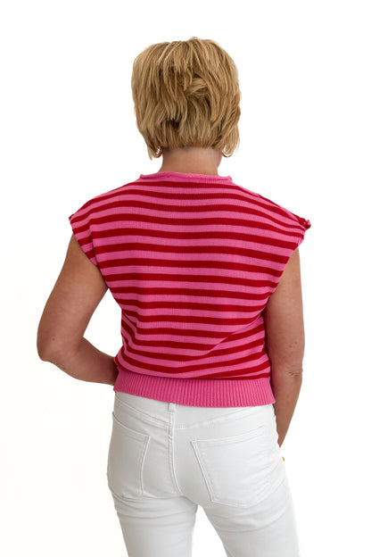 Back view of woman wearing Swagger Boutique’s Pink &amp; Red Striped Sleeveless Button Up Sweater by Entro with jeans against white studio background.